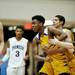 Ypsilanti freshman Corey Allen is restrained by teammates and a referee after making contact with a Pioneer player on Monday March 4. Daniel Brenner I AnnArbor.com